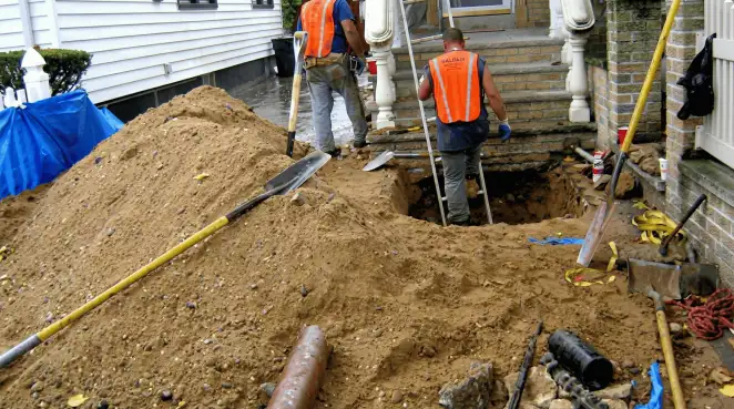 Contractors performing foundation protection and exterior drainage excavation near residential home steps in Portland, OR