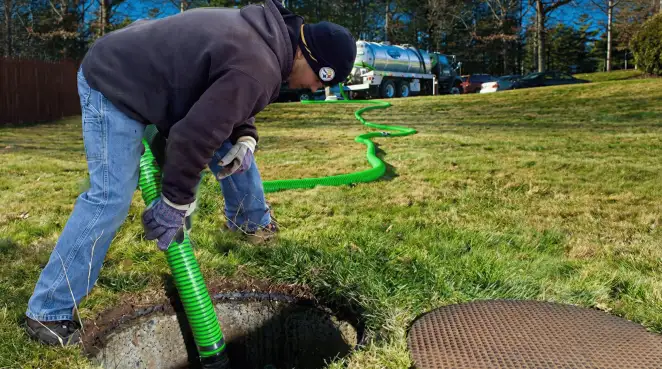 Service technician performing residential septic pumping and drainage maintenance in Portland, OR